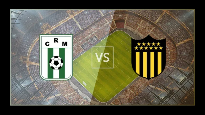 Cầu thủ Racing Montevideo chạy nhanh với bóng trước sự áp đảo từ cầu thủ Penarol